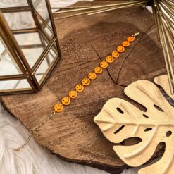 Pulsera happy face naranja neon + pintura chapa de oro 18k